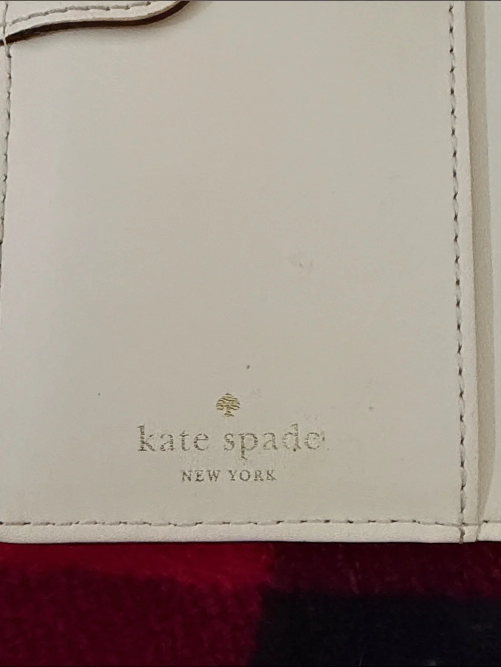 Kate Spade New York Staci large slim bifold wallet in a red currant shade
